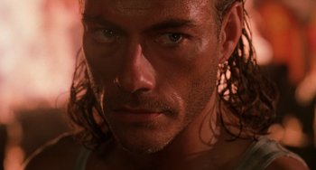 Movie still from “Hard Target” (1993), directed by John Woo – A person with long hair; Close Up shot, Low angle