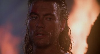 Movie still from “Hard Target” (1993), directed by John Woo – Close up of a man with long hair and piercing; Close Up shot, Low angle