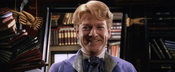 Movie still from “Harry Potter and the Chamber of Secrets” (2002), directed by Chris Columbus – A person wearing a suit and tie; Close Up shot, Low angle