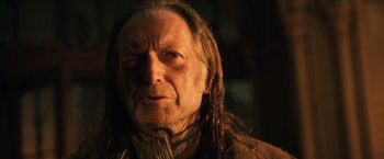 Movie still from “Harry Potter and the Chamber of Secrets” (2002), directed by Chris Columbus – An old man with long hair and a beard; Close Up shot, Low angle