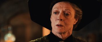 Movie still from “Harry Potter and the Chamber of Secrets” (2002), directed by Chris Columbus – An older woman wearing a black hat looking at the camera; Close Up shot, Low angle