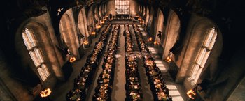 Movie still from “Harry Potter and the Chamber of Secrets” (2002), directed by Chris Columbus – A large room filled with lots of tables of food; Extreme Wide shot, High angle