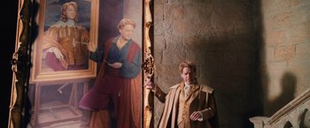 Movie still from “Harry Potter and the Chamber of Secrets” (2002), directed by Chris Columbus – A man standing next to a painting of a man; Medium shot, Over the shoulder angle