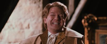 Movie still from “Harry Potter and the Chamber of Secrets” (2002), directed by Chris Columbus – A person laughing with his eyes closed; Close Up shot, Low angle