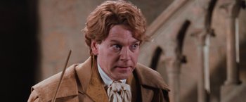 Movie still from “Harry Potter and the Chamber of Secrets” (2002), directed by Chris Columbus – A person wearing a suit and tie; Close Up shot, Over the shoulder angle