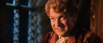 Movie still from “Harry Potter and the Chamber of Secrets” (2002), directed by Chris Columbus – A person wearing a suit and tie; Close Up shot, Low angle