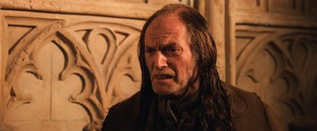 Movie still from “Harry Potter and the Chamber of Secrets” (2002), directed by Chris Columbus – An old man with long hair and a goatee; Close Up shot, Low angle