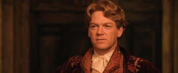 Movie still from “Harry Potter and the Chamber of Secrets” (2002), directed by Chris Columbus – A person wearing a suit and tie; Close Up shot, Low angle