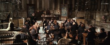 Movie still from “Harry Potter and the Chamber of Secrets” (2002), directed by Chris Columbus – A group of people sitting around a room; Wide shot, High angle