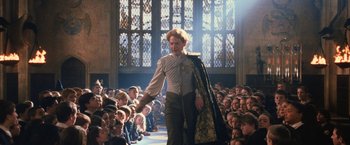 Movie still from “Harry Potter and the Chamber of Secrets” (2002), directed by Chris Columbus – A man walking in front of a group of people; Medium shot, Low angle