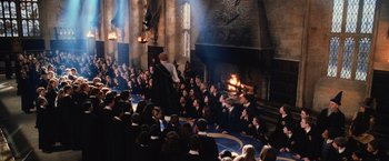 Movie still from “Harry Potter and the Chamber of Secrets” (2002), directed by Chris Columbus – A group of people sitting in front of a fireplace; Extreme Wide shot, High angle