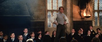 Movie still from “Harry Potter and the Chamber of Secrets” (2002), directed by Chris Columbus – A man standing in front of a group of people; Medium shot, Low angle
