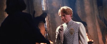 Movie still from “Harry Potter and the Chamber of Secrets” (2002), directed by Chris Columbus – A man holding a wand in front of an animal; Close Up shot, Over the shoulder angle