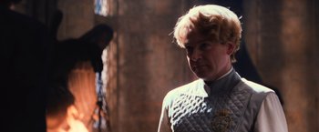 Movie still from “Harry Potter and the Chamber of Secrets” (2002), directed by Chris Columbus – A man with blonde curly hair wearing a white shirt; Close Up shot, Over the shoulder angle