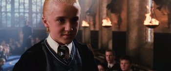 Movie still from “Harry Potter and the Chamber of Secrets” (2002), directed by Chris Columbus – A young boy in a tie and sweater; Close Up shot, Low angle