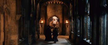 Movie still from “Harry Potter and the Chamber of Secrets” (2002), directed by Chris Columbus – Two people are standing in front of an angel statue; Wide shot, High angle