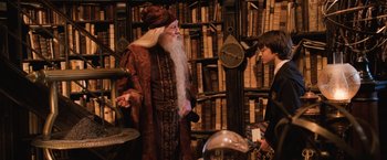 Movie still from “Harry Potter and the Chamber of Secrets” (2002), directed by Chris Columbus – A man dressed as dumbledore talking to a boy; Medium shot, Over the shoulder angle
