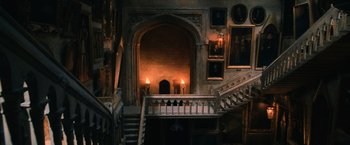 Movie still from “Harry Potter and the Chamber of Secrets” (2002), directed by Chris Columbus – Two lit candles on a staircase in an old building; Extreme Wide shot, High angle