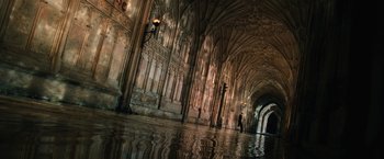 Movie still from “Harry Potter and the Chamber of Secrets” (2002), directed by Chris Columbus – A person walking in a hallway of a building; Extreme Wide shot, High angle