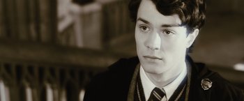 Movie still from “Harry Potter and the Chamber of Secrets” (2002), directed by Chris Columbus – A young man in a suit and tie looking to his left; Close Up shot, High angle