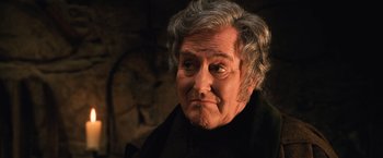 Movie still from “Harry Potter and the Chamber of Secrets” (2002), directed by Chris Columbus – An old woman with a sad look on her face; Close Up shot, High angle