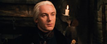 Movie still from “Harry Potter and the Chamber of Secrets” (2002), directed by Chris Columbus – A person with a candle in the background; Close Up shot, Low angle