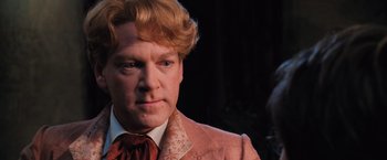 Movie still from “Harry Potter and the Chamber of Secrets” (2002), directed by Chris Columbus – A person wearing a suit and tie; Close Up shot, Low angle