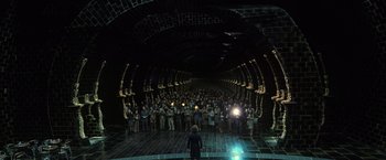 Movie still from “Harry Potter and the Deathly Hallows: Part 1” (2010), directed by David Yates – A group of people standing in a tunnel; Extreme Wide shot, High angle