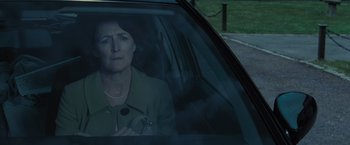 Movie still from “Harry Potter and the Deathly Hallows: Part 1” (2010), directed by David Yates – A woman sitting in the passenger seat of a car; Medium shot, Over the shoulder angle
