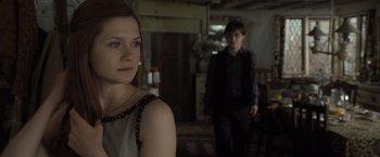 Movie still from “Harry Potter and the Deathly Hallows: Part 1” (2010), directed by David Yates – A young man and a young woman standing in a room; Medium shot, Over the shoulder angle
