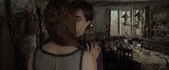 Movie still from “Harry Potter and the Deathly Hallows: Part 1” (2010), directed by David Yates – A man and a woman are hugging in a room; Close Up shot, Over the shoulder angle