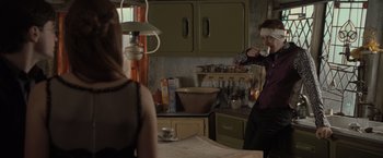 Movie still from “Harry Potter and the Deathly Hallows: Part 1” (2010), directed by David Yates – A man and a woman are drinking coffee in a kitchen; Medium shot, Over the shoulder angle