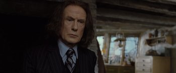Movie still from “Harry Potter and the Deathly Hallows: Part 1” (2010), directed by David Yates – A person wearing a suit and tie; Close Up shot, Over the shoulder angle
