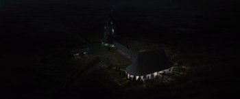 Movie still from “Harry Potter and the Deathly Hallows: Part 1” (2010), directed by David Yates – An aerial view of a tent city at night; Extreme Wide shot, High angle
