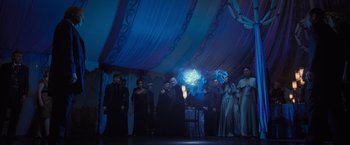 Movie still from “Harry Potter and the Deathly Hallows: Part 1” (2010), directed by David Yates – A group of people standing under a blue tent; Wide shot, Low angle