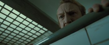Movie still from “Harry Potter and the Deathly Hallows: Part 1” (2010), directed by David Yates – A person looking over a railing; Close Up shot, Low angle