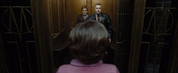 Movie still from “Harry Potter and the Deathly Hallows: Part 1” (2010), directed by David Yates – A man and a woman are standing in a elevator; Medium shot, Low angle