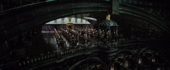 Movie still from “Harry Potter and the Deathly Hallows: Part 1” (2010), directed by David Yates – A large room filled with tables and chairs; Extreme Wide shot, High angle