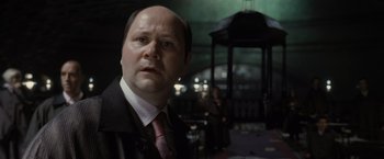 Movie still from “Harry Potter and the Deathly Hallows: Part 1” (2010), directed by David Yates – A man in a suit and tie in front of a gazebo; Close Up shot, Low angle