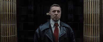 Movie still from “Harry Potter and the Deathly Hallows: Part 1” (2010), directed by David Yates – A man wearing a leather jacket and a red tie; Close Up shot, Low angle