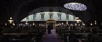 Movie still from “Harry Potter and the Deathly Hallows: Part 1” (2010), directed by David Yates – A man in a black robe standing in front of a building; Extreme Wide shot, High angle