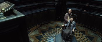 Movie still from “Harry Potter and the Deathly Hallows: Part 1” (2010), directed by David Yates – Two people sitting on a bench in a room; Wide shot, High angle