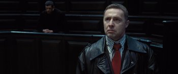Movie still from “Harry Potter and the Deathly Hallows: Part 1” (2010), directed by David Yates – A man wearing a leather jacket and a red tie; Close Up shot, Low angle