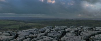 Movie still from “Harry Potter and the Deathly Hallows: Part 1” (2010), directed by David Yates – A view of a cloudy sky over a rocky landscape; Extreme Wide shot, High angle