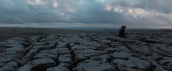 Movie still from “Harry Potter and the Deathly Hallows: Part 1” (2010), directed by David Yates – A man standing on top of a rocky hill; Extreme Wide shot, High angle
