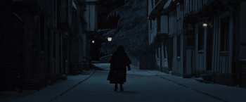 Movie still from “Harry Potter and the Deathly Hallows: Part 1” (2010), directed by David Yates – A person walking down a street at night; Wide shot, High angle