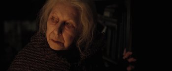 Movie still from “Harry Potter and the Deathly Hallows: Part 1” (2010), directed by David Yates – An old woman with white blonde hair and green eyes looking at the camera; Close Up shot, Low angle