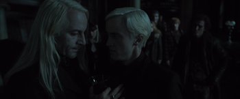 Movie still from “Harry Potter and the Deathly Hallows: Part 1” (2010), directed by David Yates – Two men in a dark room one of them is holding a drink; Close Up shot, Over the shoulder angle