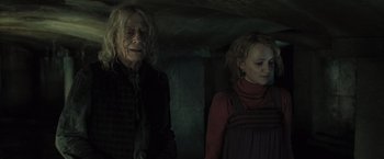 Movie still from “Harry Potter and the Deathly Hallows: Part 1” (2010), directed by David Yates – A man and a woman standing next to each other; Medium shot, Low angle