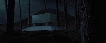 Movie still from “Harry Potter and the Deathly Hallows: Part 1” (2010), directed by David Yates – A concrete structure sitting in the middle of a forest at night; Extreme Wide shot, Low angle